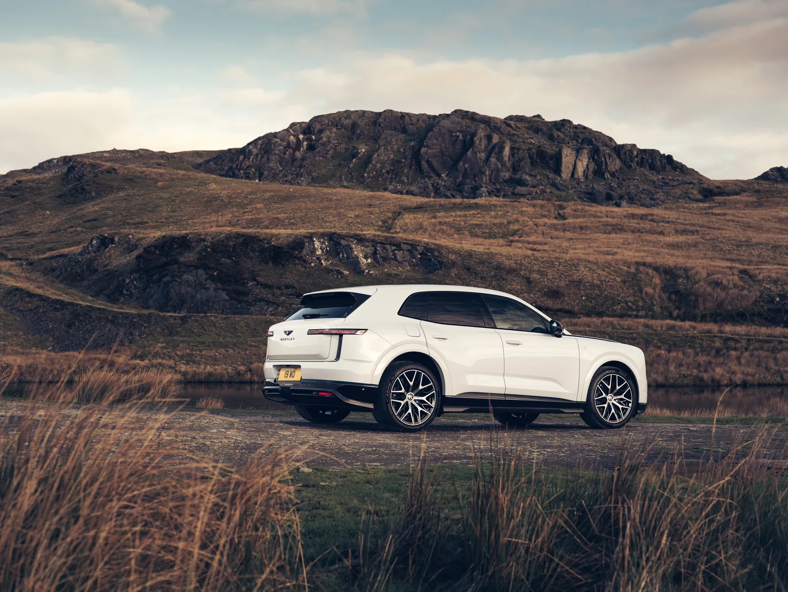 White Bentley Torcal First Edition photographed from a rear three-quarter angle in an open landscape.